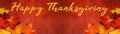 Happy Thanksgiving / autumn background banner panorama - Colorful fallen autumnal leaves on rustic red wooden wall / table texture Royalty Free Stock Photo