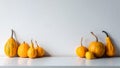 Happy Thanksgiving Background. Selection of various pumpkins on white shelf against white wall. Autumn inspired room decoration. Royalty Free Stock Photo