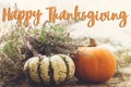 Happy Thanksgiving Card. Happy thanksgiving text on pumpkins, heather on rustic old wood in light. Season`s greetings, handwritte Royalty Free Stock Photo