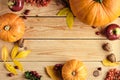 Happy Thanksgiving concept. Autumn frame made of ripe orange pumpkins, fallen leaves, dry flowers on rustic wooden table. Flat lay Royalty Free Stock Photo