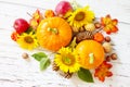 Happy Thanksgiving concept. Pumpkins, sunflowers, apples and fallen leaves on rustic wooden table. Royalty Free Stock Photo