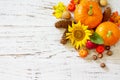 Happy Thanksgiving concept. Pumpkins, sunflowers, apples and fallen leaves on rustic wooden table. Top view flat lay. Royalty Free Stock Photo