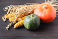 Happy Thanksgiving Day background, wooden table decorated with Pumpkins, Corncob, Candles and autumn leaves garland. Beautiful Hol Royalty Free Stock Photo