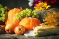 Happy Thanksgiving Day background, wooden table decorated with Pumpkins, Maize, fruits and autumn leaves. Harvest Royalty Free Stock Photo