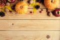 Happy Thanksgiving day concept. Autumn frame made of ripe orange pumpkins, fallen leaves, fruits, nuts on rustic wooden table. Royalty Free Stock Photo