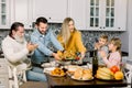 Happy Thanksgiving Day. Family sitting at the table and celebrating holiday. Traditional dinner. Three generations of Royalty Free Stock Photo