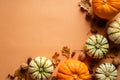 Happy Thanksgiving day postcard design. Flat lay pumpkins, dry oak leaves, acorns, cones on orange background. Autumn, fall Royalty Free Stock Photo