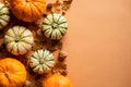 Happy Thanksgiving day postcard template. Flat lay pumpkins, dry oak leaves, acorns, cones on orange background. Autumn, fall Royalty Free Stock Photo