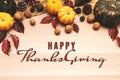 Happy Thanksgiving Day with pumpkin and nut on wooden background Royalty Free Stock Photo