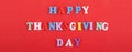 HAPPY THANKSGIVING DAY word on red background composed from colorful abc alphabet block wooden letters, copy space for ad text. Royalty Free Stock Photo