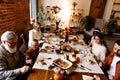 Happy Thanksgiving dinner party with family and friends with turkey and holiday traditional food, dishes on table. Royalty Free Stock Photo