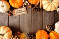 Happy Thanksgiving gift tag with double border of pumpkins and autumn decor over a wood background Royalty Free Stock Photo