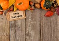 Happy Thanksgiving tag with autumn top border over wood Royalty Free Stock Photo