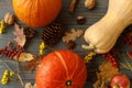 Happy Thanksgiving greeting card. Pumpkins, autumn leaves, apples, anise, cones, acorns and flowers on dark wooden background. Royalty Free Stock Photo