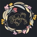 Happy Thanksgiving hand lettering inside a wreath on black background Royalty Free Stock Photo