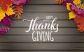 Happy Thanksgiving holiday banner, congratulation text. Autumn tree leaves border on wooden background, top view. Holiday design Royalty Free Stock Photo