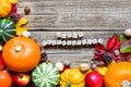 Happy thanksgiving inscription. Autumn Fall background with harvested pumpkins, apples, nuts and maple leaves Royalty Free Stock Photo