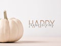 Happy Thanksgiving message with white colored Autumn pumpkin on wooden table against white background Royalty Free Stock Photo
