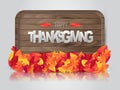Happy Thanksgiving poster.  Background with red and orange fall leaves on wooden board with a surface reflection. American traditi Royalty Free Stock Photo
