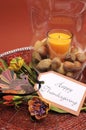 Happy Thanksgiving table setting centerpiece with ornage candle and nuts - vertical Royalty Free Stock Photo