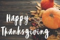 Happy Thanksgiving Text on beautiful composition of Pumpkin, autumn vegetables with colorful leaves,acorns,nuts, berries on