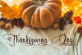 Happy thanksgiving text. In home decorated Pumpkin, cones, walnuts and autumn leaves garland. autumn fall holidays. Cozy mood Royalty Free Stock Photo