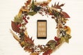 Happy Thanksgiving text on phone empty screen in autumn leaves w