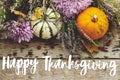Happy thanksgiving text on pumpkins, dahlias flowers, heather on rustic old wood flat lay. Seasonal greeting card, handwritten Royalty Free Stock Photo