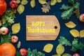 Happy Thanksgiving text with pumpkins and leaves over dark wood background Royalty Free Stock Photo