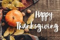 Happy thanksgiving text sign flat lay. pumpkin with leaves and