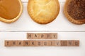 Happy Thanksgiving on a White Wood Table with Various Pies Royalty Free Stock Photo