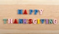 HAPPY THANKSGIVING word on wooden background composed from colorful abc alphabet block wooden letters, copy space for ad text. Royalty Free Stock Photo