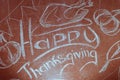 Happy Thanksgiving, written in white chalk on a blackboard,