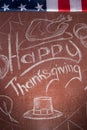 Happy Thanksgiving, written in white chalk on a blackboard,