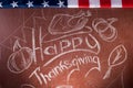 Happy Thanksgiving, written in white chalk on a blackboard,