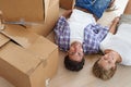 Happy in their new home. Portrait happy young couple holding hands while lying on the floor in their new home and Royalty Free Stock Photo