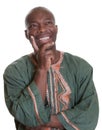 Happy thinking african man with traditional clothes