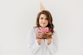 a happy thirty-year-old woman with a birthday cake with candles.