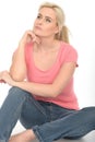 Happy Thoughtful Attractive Young Woman Sitting on the Floor Relaxing Royalty Free Stock Photo