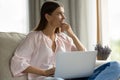 Happy thoughtful student girl studying from home, sitting on couch Royalty Free Stock Photo