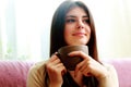 Happy thoughtful woman holding cup of coffee Royalty Free Stock Photo