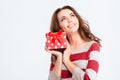 Happy thoughtful woman holding gift box and looking up Royalty Free Stock Photo