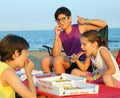 Happy three brothers eating pizza Royalty Free Stock Photo