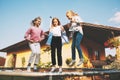 Happy three children are jumping on a trampoline in the garden near their house. Royalty Free Stock Photo