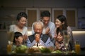 Three generation asian family celebrating grandpa`s birthday at home