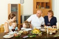 Happy three generations family over dining table at home Royalty Free Stock Photo