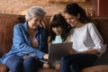Happy three generations of women relax using laptop Royalty Free Stock Photo