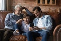 Happy three generations of men having fun with smartphone Royalty Free Stock Photo