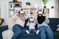 Happy three generations of muslim women watching in modern augmented vr headset reality glasses Royalty Free Stock Photo