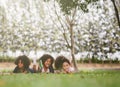 Happy three little friends laying on the grass in the park. american african children playing toy in park. Royalty Free Stock Photo